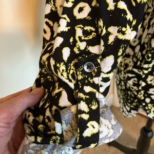 Blouse, unusual animal type print. Longer in the back with sleeve straps.